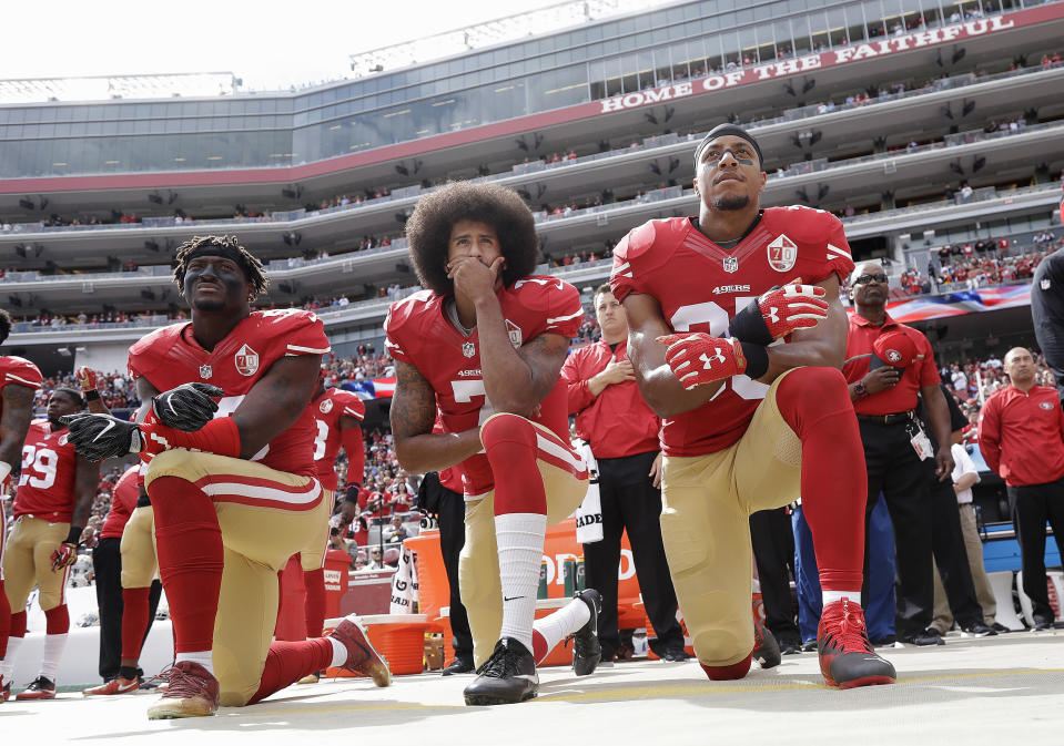San Francisco 49ers' Eli Harold, Colin Kaepernick and Eric Reid kneel during the national anthem before an NFL game in 2016. (AP Photo/Marcio Jose Sanchez, File)