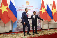 In this photo released by Russian Foreign Ministry Press Service, Russian Foreign Minister Sergey Lavrov, left, and Vietnamese Foreign Minister Bui Thanh Son pose for a photo during their meeting in Hanoi, Vietnam on Wednesday, July 6, 2022. Lavrov is on a trip to Asia to seek support amid his country's diplomatic isolation by the West and punishing sanctions leveled over its invasion of Ukraine. (Russian Foreign Ministry Press Service via AP)