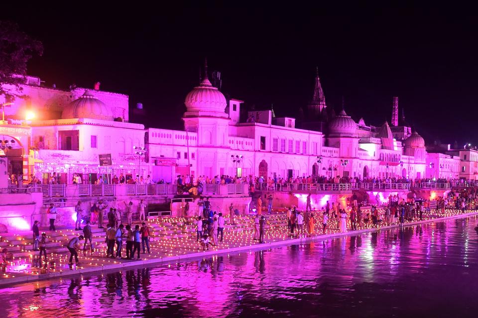 Hindu devotees light earthen lamps on the banks of the River Sarayu on the eve before the groundbreaking ceremony of the proposed Ram Temple in Ayodhya on August 4, 2020. - India's Prime Minister Narendra Modi will lay the foundation stone for a grand Hindu temple in a highly anticipated ceremony at a holy site that was bitterly contested by Muslims, officials said. The Supreme Court ruled in November 2019 that a temple could be built in Ayodhya, where Hindu zealots demolished a 460-year-old mosque in 1992. (Photo by SANJAY KANOJIA / AFP) (Photo by SANJAY KANOJIA/AFP via Getty Images)