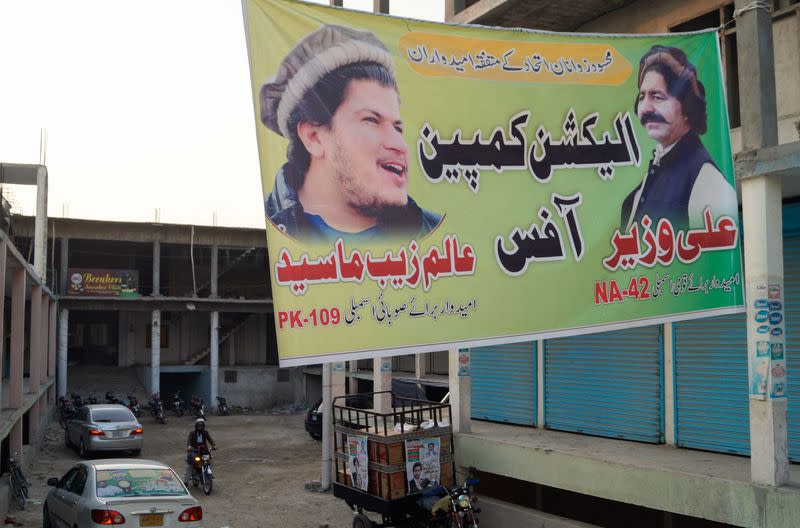 Election campaign banner of Ali Wazir and Alam Zeb Mehsud, independent candidates for general election from South Waziristan, hangs over a street in Dera Ismail Khan