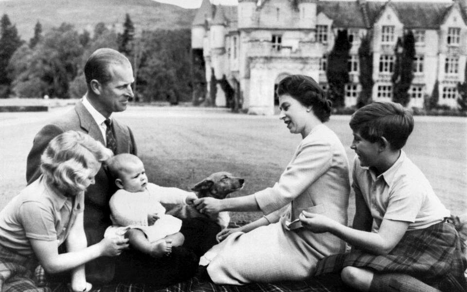 Prince Philip and the Queen with their children on the ground of Balmoral - AFP