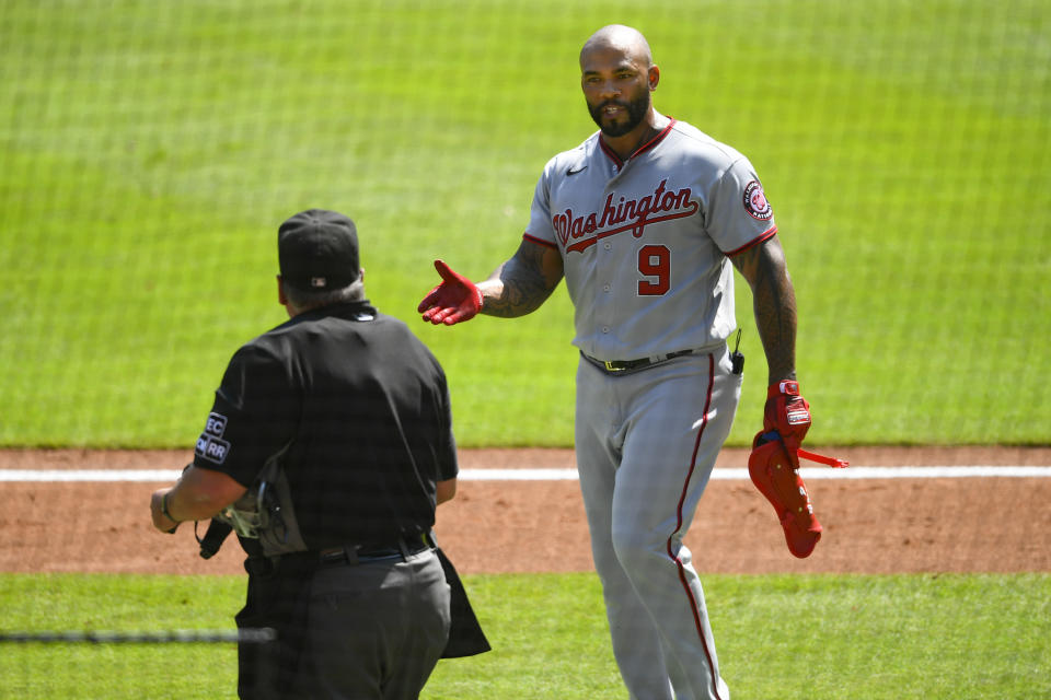 Washington Nationals' Eric Thames talks to an umpire after striking out against the Atlanta Braves during the seventh inning of a baseball game Sunday, Sept. 6, 2020, in Atlanta. (AP Photo/John Amis)