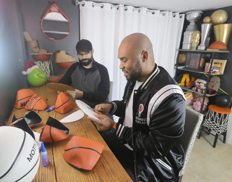 Mylan Murphy guides Beacon Journal reporter Nate Ulrich through a shelf project in his Motivated By Mylan business studio on Wednesday, Dec. 7, 2022 in Fairlawn, Ohio.