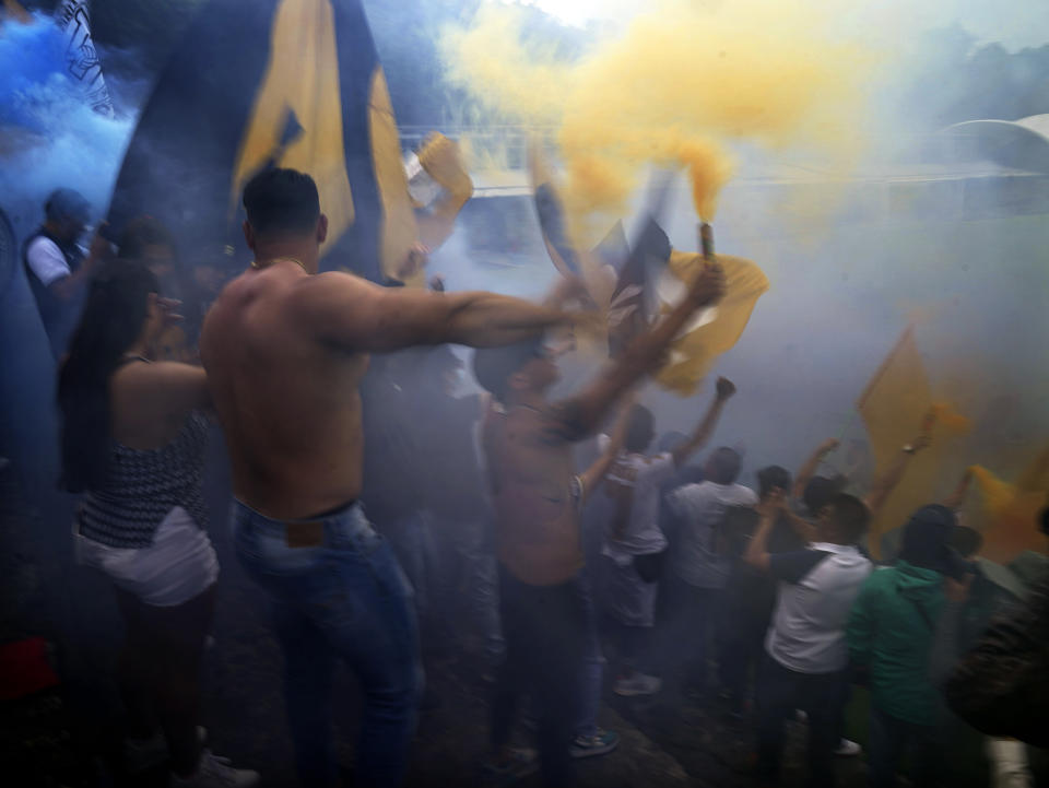 Fans celebrate as Brazilian Dani Alves is presented as a team member of the Pumas UNAM soccer club, at the Pumas training facility in Mexico City, Saturday, July 23, 2022. (AP Photo/Marco Ugarte)