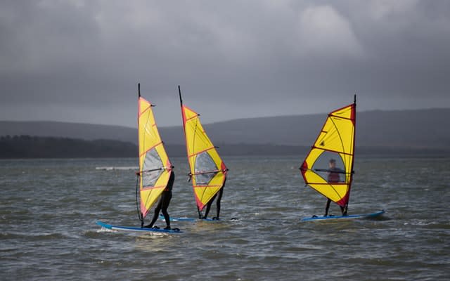 These windsurfers took advantage of the stormy conditions on the Rock Lea river near to Poole in Dorset