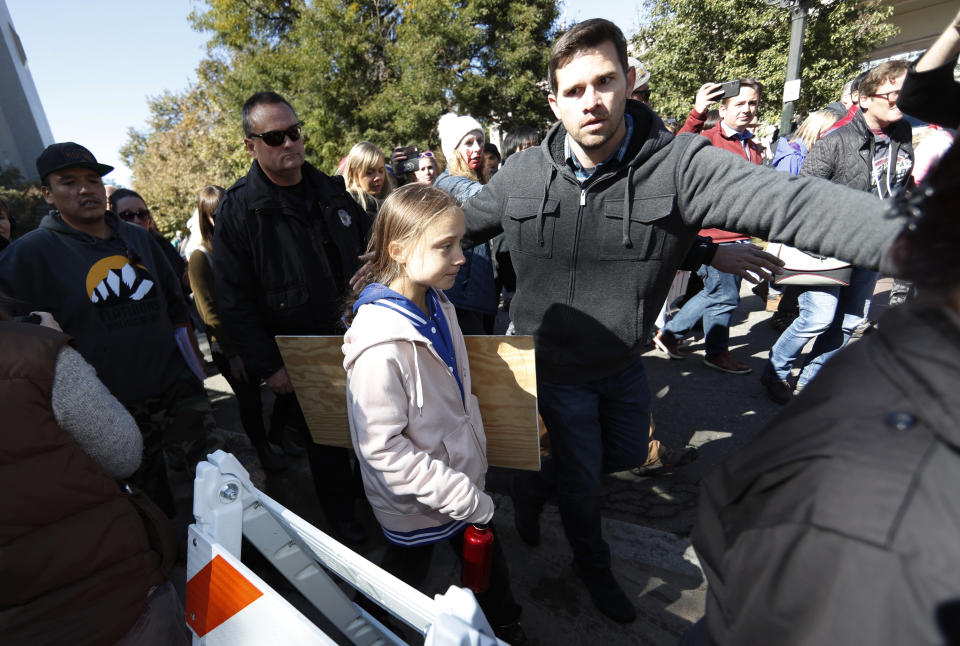 Escorted by a flotilla of police officers, Swedish climate activist Greta Thunberg, center, is led away after speaking to several thousand people at a climate strike rally Friday, Oct. 11, 2019, in Denver. The rally was staged in Denver's Civic Center Park. (AP Photo/David Zalubowski)