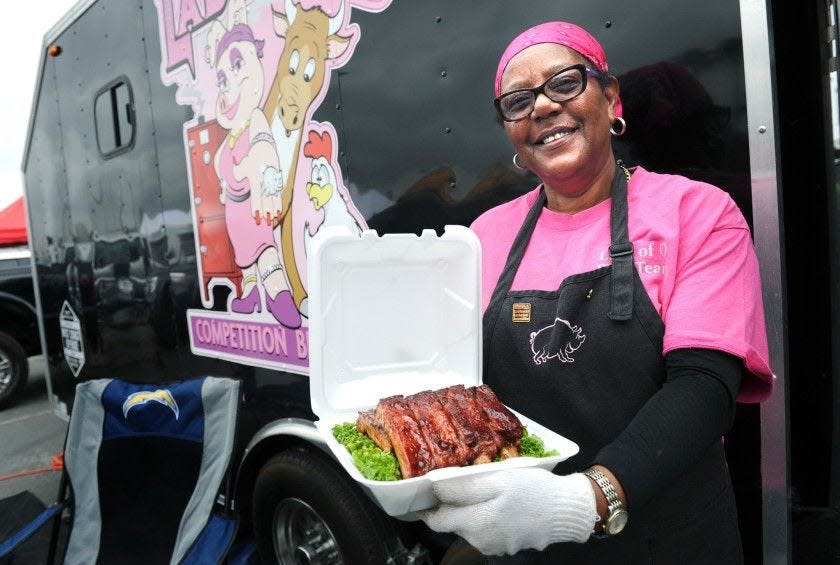 American Barbecue Showdown contestant Sylvie Curry shows off a platter of ribs