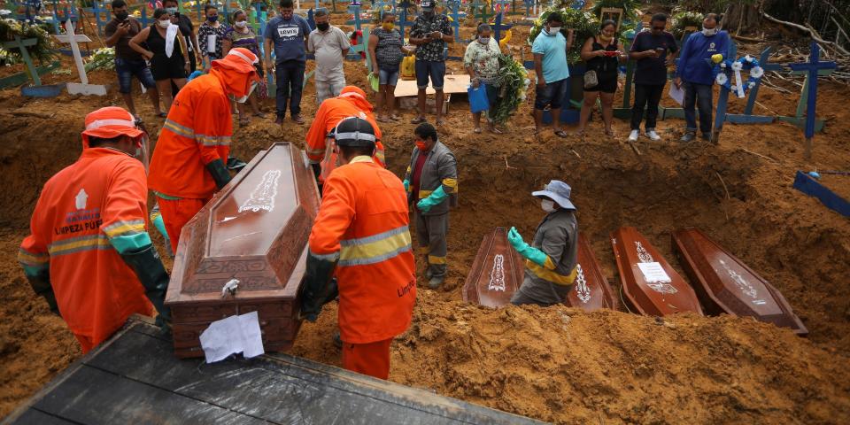 Gravediggers carry a coffin during a collective burial of people that have passed away due to the coronavirus disease (COVID 19), at the Parque Taruma cemetery in Manaus, Brazil April 28, 2020..JPG