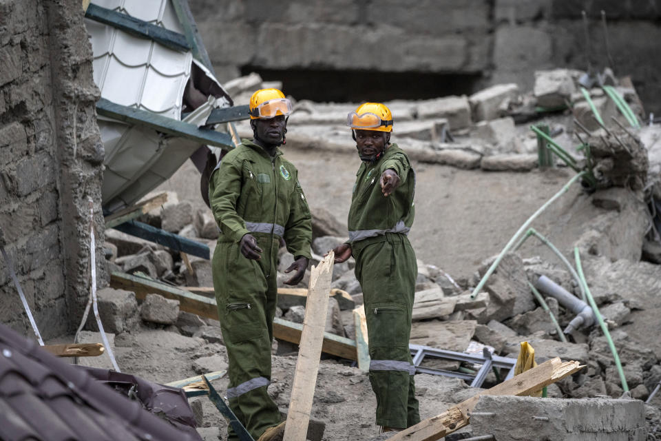 Personnel from the Kenya Defence Forces disaster response unit examine the scene of a building collapse in the Kasarani neighborhood of Nairobi, Kenya Tuesday, Nov. 15, 2022. Workers at the multi-storey residential building that was under construction are feared trapped in the rubble and rescue operations have begun, but there was no immediate official word on any casualties. (AP Photo/Ben Curtis)