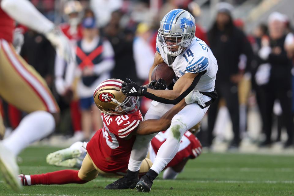 Detroit Lions wide receiver Amon-Ra St. Brown (14) is tackled by San Francisco 49ers cornerback Ambry Thomas (20) during the first half of the NFC Championship NFL football game in Santa Clara, Calif., Sunday, Jan. 28, 2024. (AP Photo/Jed Jacobsohn)