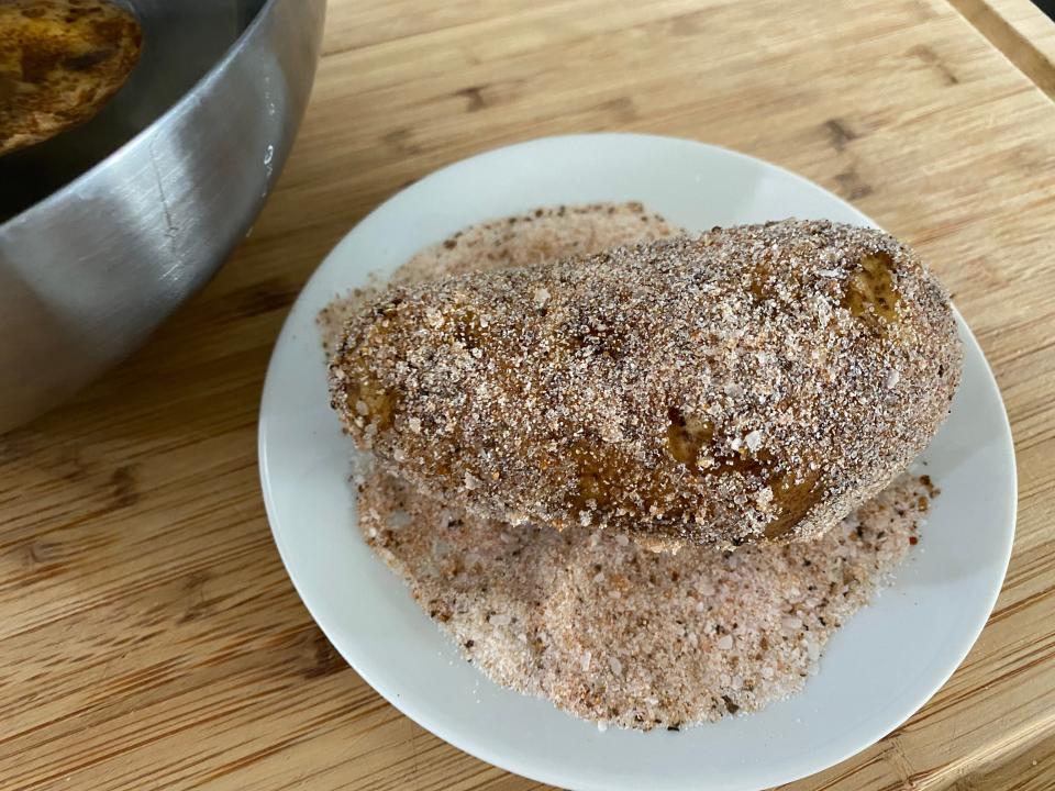 baked potato rolling in guy fieri salt mixture