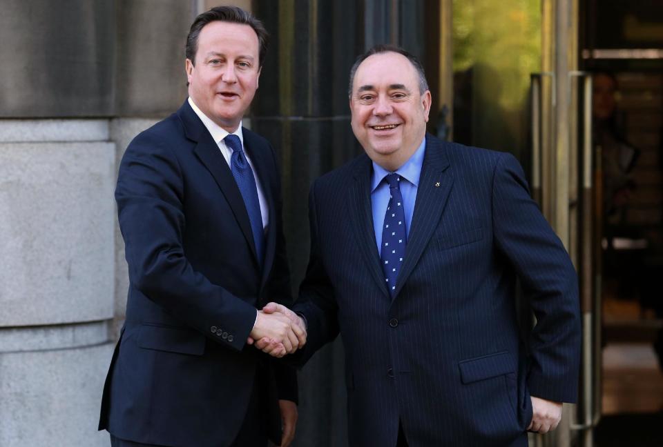 Britain's Prime Minister, David Cameron, left, shakes hands with Scotland's First Minister Alex Salmond at St Andrews House in Edinburgh, where he is expected to sign a deal granting Holyrood the power to hold a historic referendum on independence, Monday Oct. 15, 2012. Officials from London and Edinburgh have been meeting for weeks to hammer out details of a vote on Scottish independence. Sticking points included the date and the wording of the question. (AP Photo/PA, Andrew Milligan) UNITED KINGDOM OUT NO SALES NO ARCHIVE