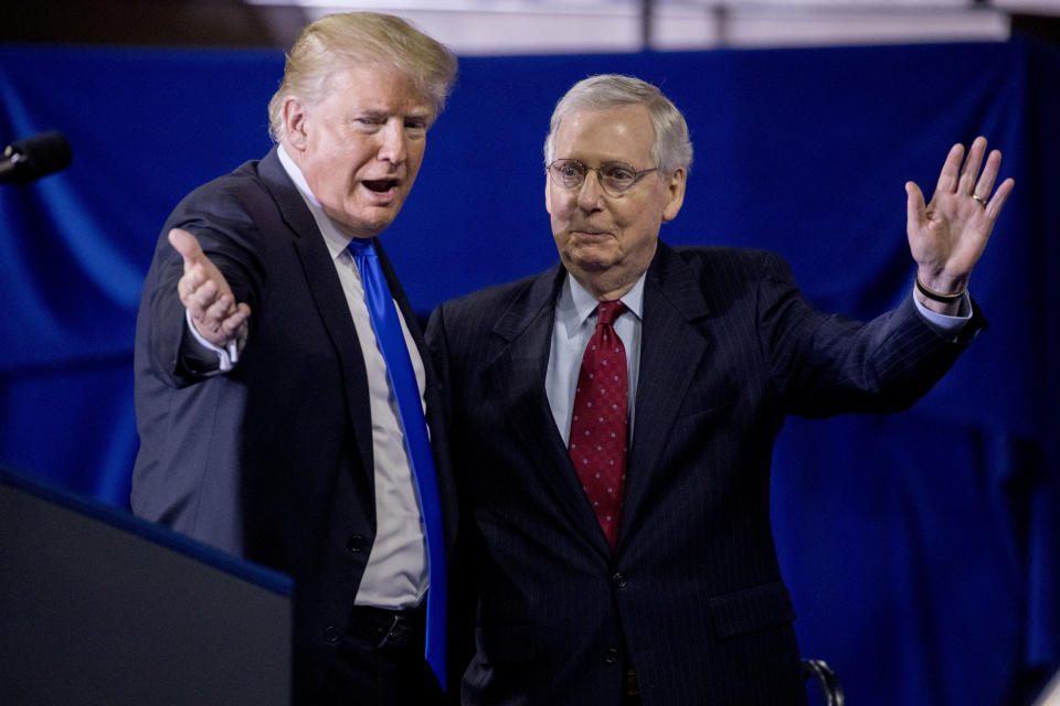 President Donald Trump, left, invites Senate Majority Leader Mitch McConnell, of Ky., right, onstage as he speaks at a rally at Alumni Coliseum in Richmond, Ky., Saturday, Oct. 13, 2018. (AP Photo/Andrew Harnik)