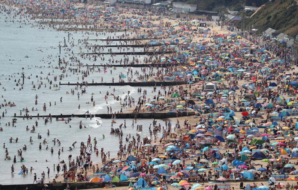 People on a beach in Dorset on Saturday (PA)
