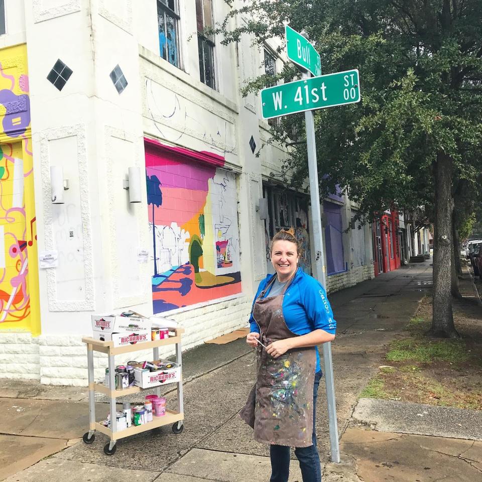 Local Artist Dana Richardson stands in front of her mural on the corner of 41st and Bull street. This mural was Richardson's first large scale mural work and public art piece.