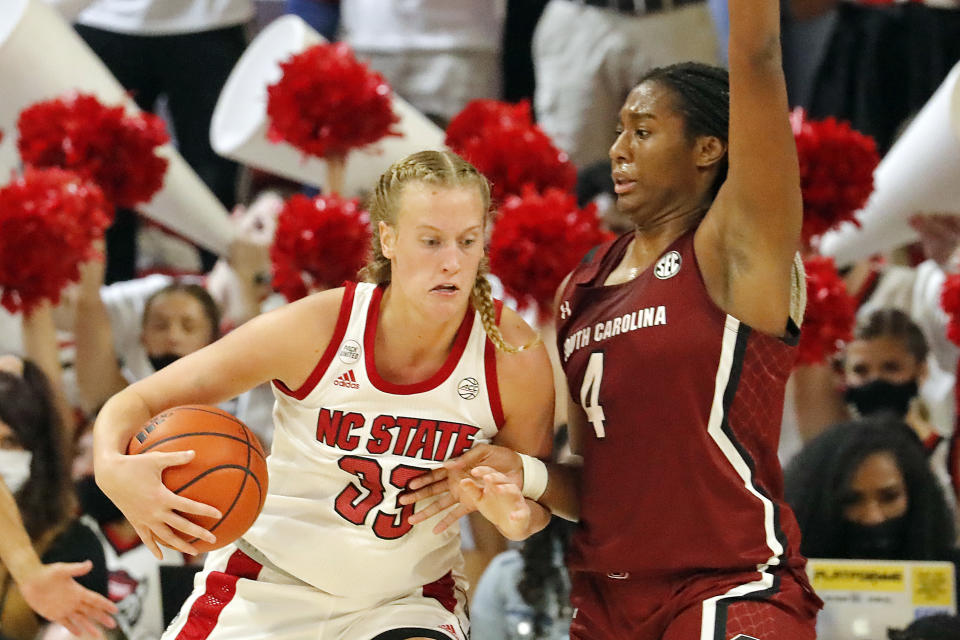 North Carolina State's Elissa Cunane (33) tries to drive the ball around South Carolina's Aliyah Boston (4) during the second half of an NCAA college basketball game, Tuesday, Nov. 9, 2021 in Raleigh, N.C. (AP Photo/Karl B. DeBlaker)