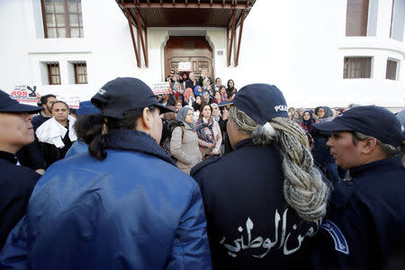 Policewomen stand guard in front of Algerian doctors, who are completing their residency stage of their studies, holding a sit-in protest in Algiers, Algeria, February 12, 2018. REUTERS/Ramzi Boudina