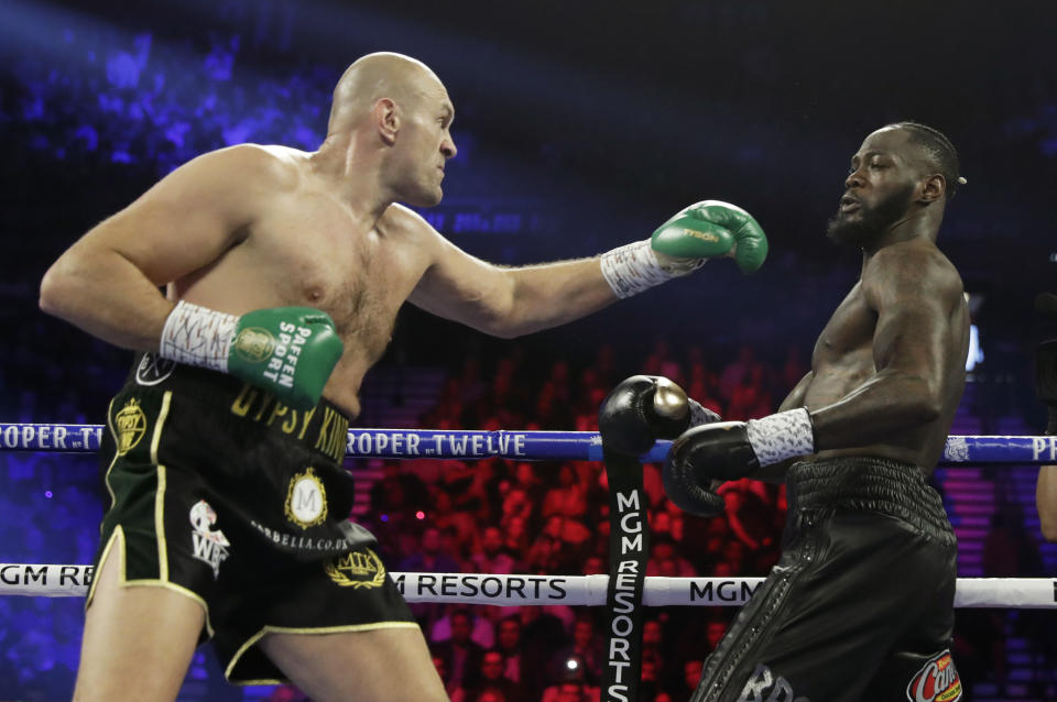 Tyson Fury, left, of England, fight Deontay Wilder during a WBC heavyweight championship boxing match Saturday, Feb. 22, 2020, in Las Vegas. (AP Photo/Isaac Brekken)