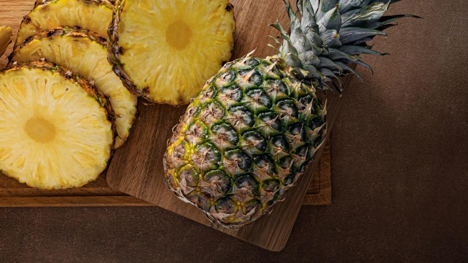 Pineapple chopped up on wooden board
