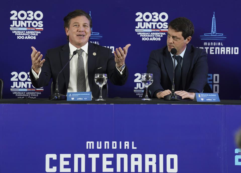 President of CONMEBOL, Alejandro Dominguez, left, speaks next Ignacio Alonso, President of the Uruguayan Football Association, during a press conference for a joint bid to host the 2030 FIFA World Cup with the hope of bringing the global showpiece back to its first home, at Centenario Stadium in Montevideo, Uruguay, Tuesday, Aug. 2, 2022. (AP Photo/Matilde Campodonico)