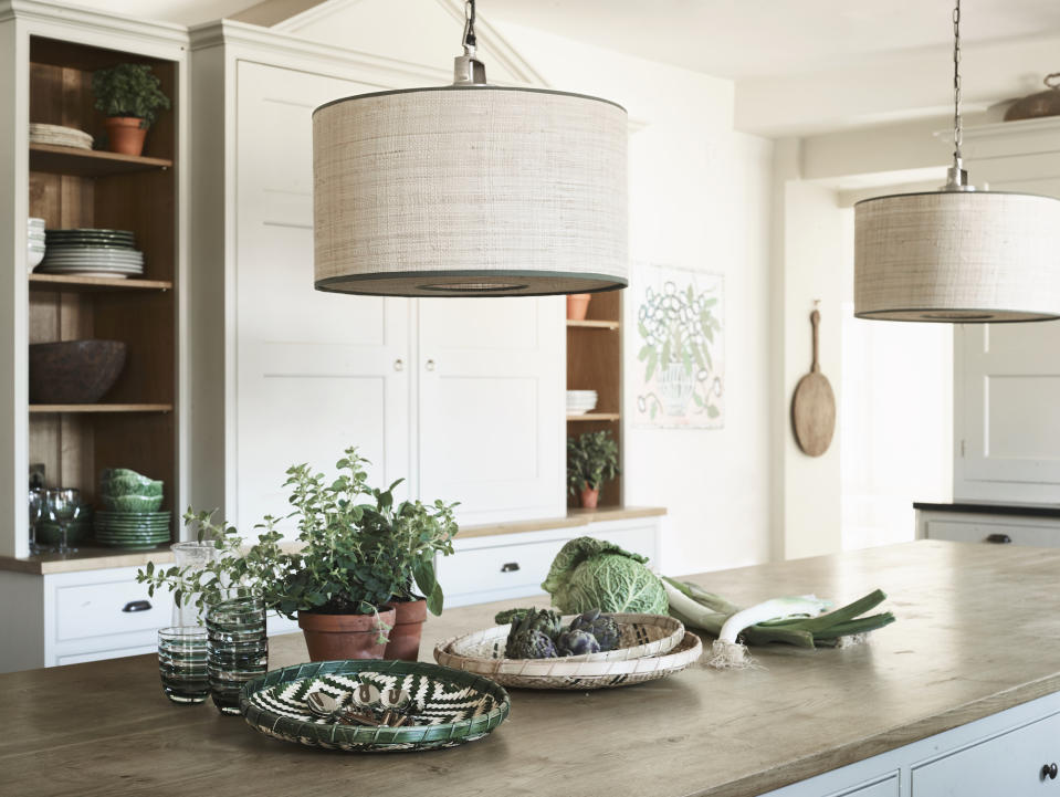 <p> Kitchen lighting can be harsh, or major on sleek and shiny surfaces. When it comes to finalizing your farmhouse decor and farmhouse kitchen lighting, you can take a softer approach.&#xA0; </p> <p> Here, the large Seema Raffia Drum Shade from Birdie Fortescue has a fabric base that filters the light above the kitchen island, while the narrow green edging adds a subtle hint of color.&#xA0; </p> <p> The result: farmhouse decor in a kitchen that has the comfort factor of a snug sitting room. </p>