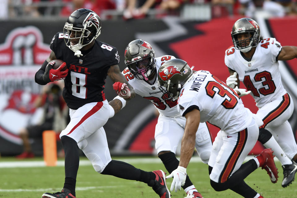 Atlanta Falcons tight end Kyle Pitts (8) gets away from Tampa Bay Buccaneers safety Mike Edwards (32), safety Antoine Winfield Jr. (31) and defensive back Ross Cockrell (43) after a catch during the first half of an NFL football game Sunday, Sept. 19, 2021, in Tampa, Fla. (AP Photo/Jason Behnken)