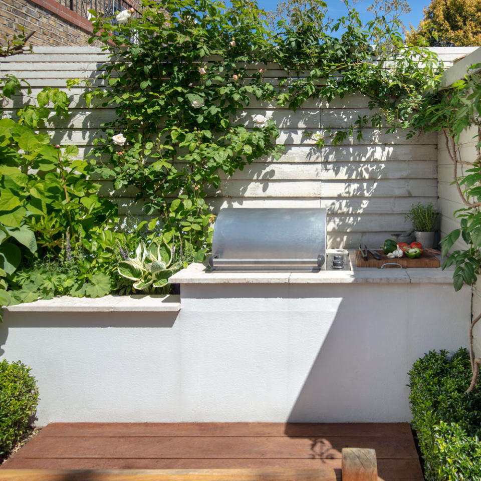 <p> Give an outdoor cooking area it's own raised decking, to add a signify a dedicated outdoor kitchen zone. The use of wooden flooring helps add an indoor style element to an outdoor kitchen. </p> <p> Also from a practical point of view a wooden decking can be easily washed down and is less likely to be damaged as a result of kitchen accidents with dropped plates and more. </p>