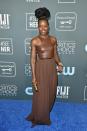 <p>Lupita Nyong'o stuns in a two-tone brown dress, complete with gold accents.</p>