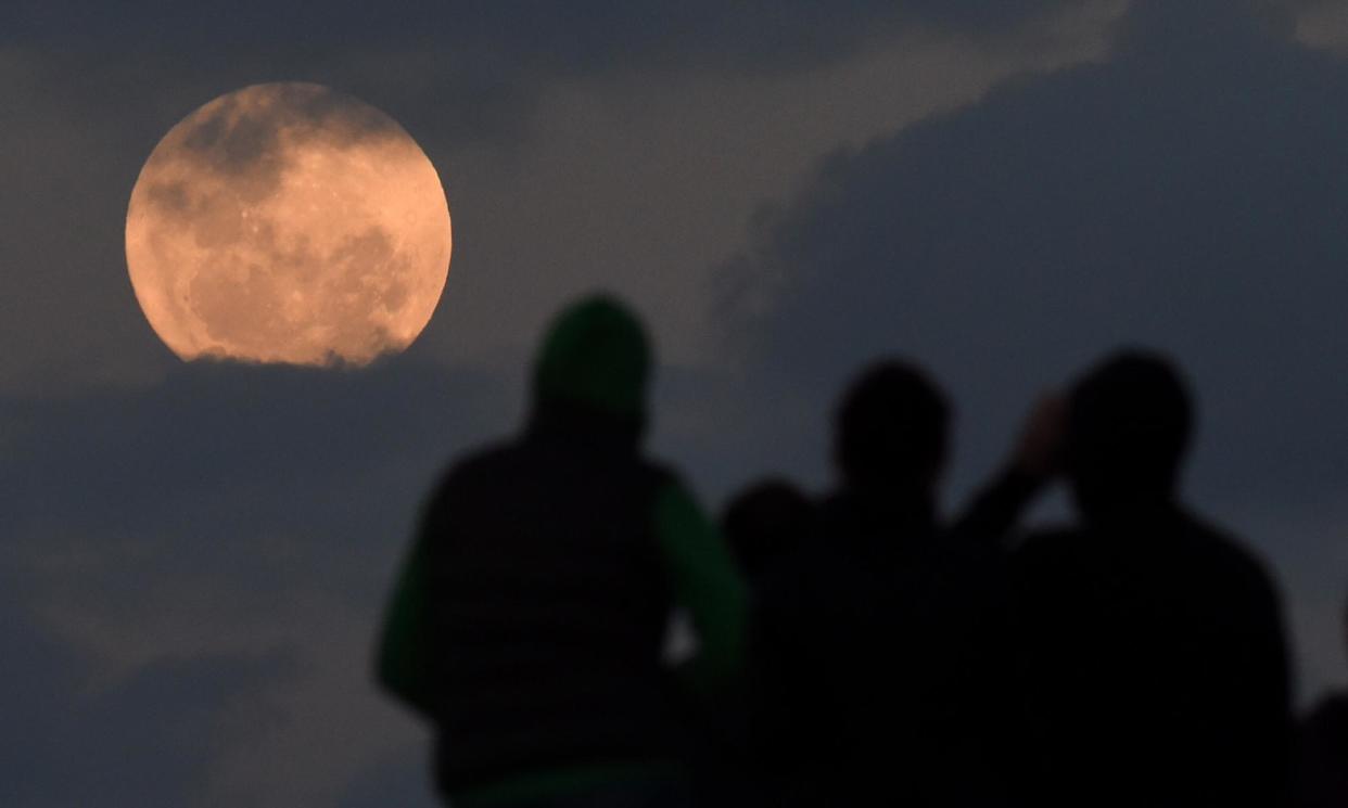 <span>People watch a full moon rising near Sydney in 2016. The best time to see the September 2024 supermoon, or harvest moon, is about 6pm Wednesday for people in Sydney and Melbourne, Australia, 7pm for London and New York and 7:30pm for the US west coast.</span><span>Photograph: Dean Lewins/AAP</span>