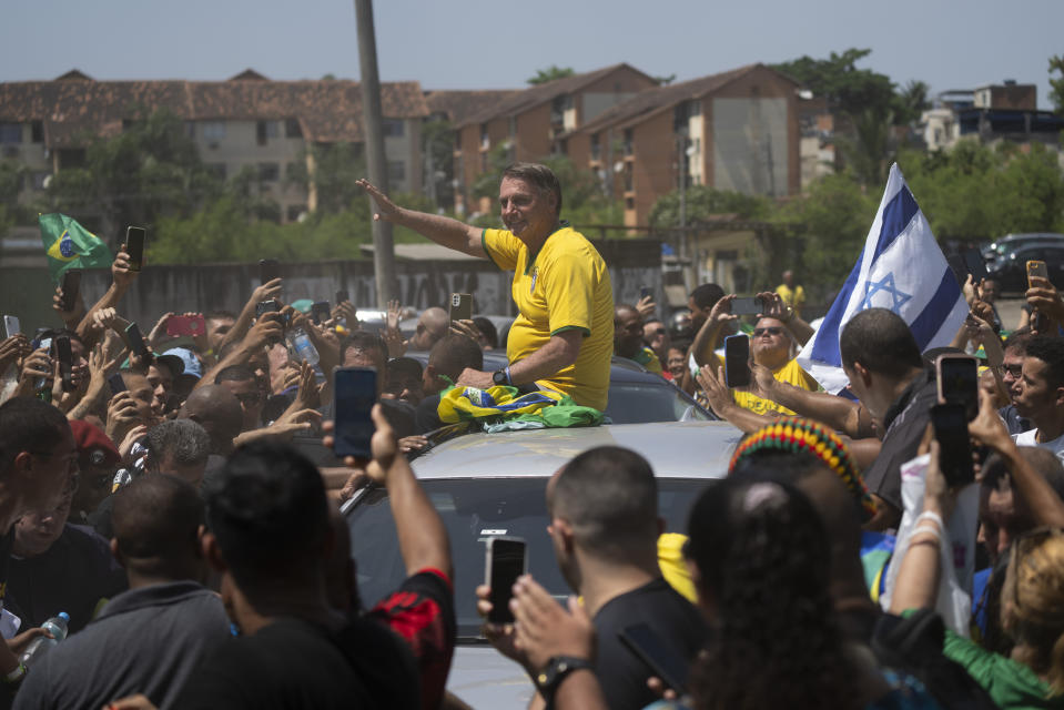 Brazil's former President Jair Bolsonaro greets supporters after attending a campaign event launching the pre-candidacy of a mayoral candidate, in Rio de Janeiro, Brazil, Saturday, March 16, 2024. (AP Photo/Silvia Izquierdo)