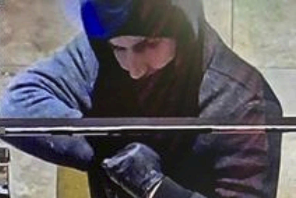 FILE - This photo provided by the Las Vegas Metropolitan Police Department shows a suspect captured by security cameras on Jan. 6, 2022, during a robbery at the Aliante hotel-casino in North Las Vegas. The police agency later identified the suspect as Caleb Rogers, who was employed as an active-duty patrol officer at the time of the robbery. The Las Vegas police officer was sentenced Tuesday, Oct. 17, 2023, to 12 years in federal prison for stealing nearly $165,000 in a trio of casino heists. (Las Vegas Metropolitan Police Department via AP, File)