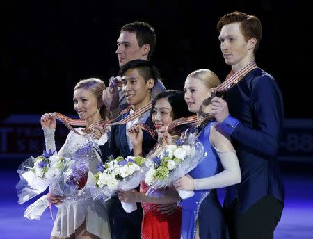 Figure Skating - ISU World Championships 2017 - Pairs Victory Ceremony - Helsinki, Finland - 30/3/17 - Gold medallists Sui Wenjing and Han Cong of China (C), silver medallists Aliona Savchenko and Bruno Massot of Germany (L) and bronze medallists Evgenia Tarasova and Vladimir Morozov of Russia attend the ceremony. REUTERS/Grigory Dukor