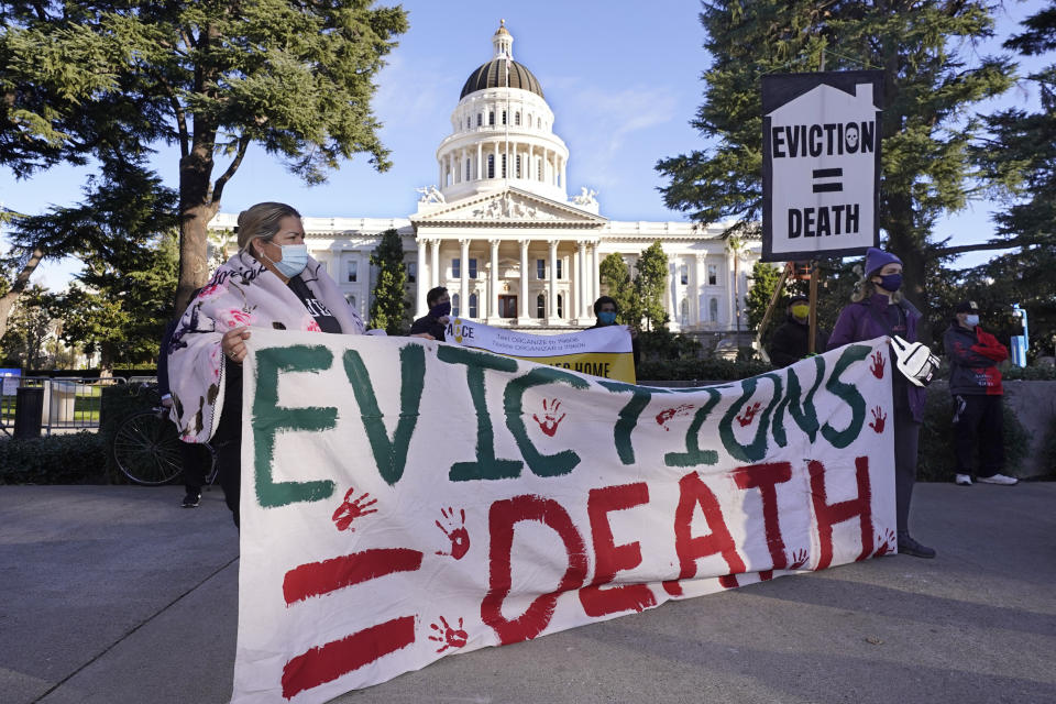 FILE - In this Jan 25, 2021 file photo demonstrators calling for lawmakers and Gov. Gavin Newsom to pass rent forgiveness and stronger eviction protections legislation, gathered in front of the Capitol in Sacramento, Calif. California's statewide eviction moratorium ends Friday, Oct. 1. But tenants with unpaid rent can still stay in their homes beyond that date if they apply for assistance from the state. California is using billions of federal dollars to pay off up to 18 months of most people's rent dating back to April 2020. (AP Photo/Rich Pedroncelli, File)