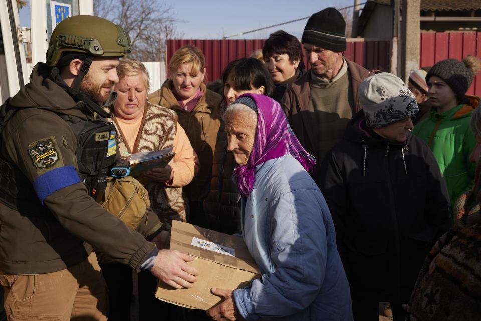 Local residents receive an aid delivery from the New Dawn team in Bilozherka, Kherson Oblast, Ukraine on March 8, 2023.
