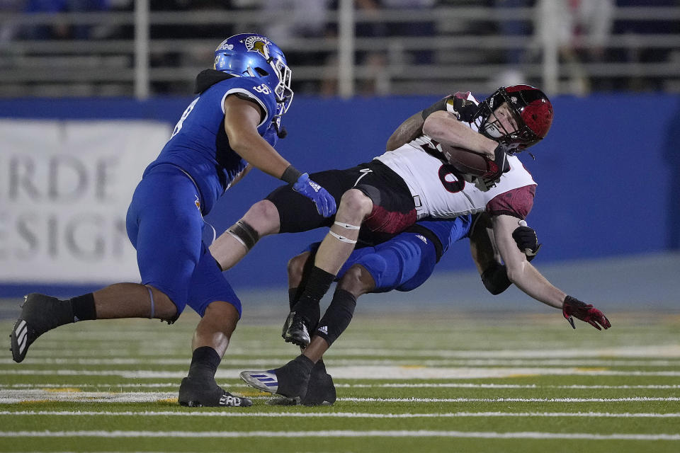 San Diego State wide receiver Elijah Kothe (96) is tackled by San Jose State cornerback Nehemiah Shelton (23) during the first half of an NCAA college football game Friday, Oct. 15, 2021, in San Jose, Calif. (AP Photo/Tony Avelar)