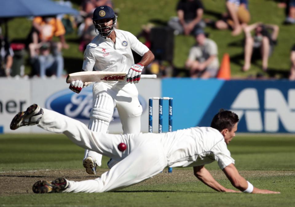 New Zealand's Trent Boult fails to field a shot from India's Shikhar Dhawan during the first innings on day one of the second international test cricket match at the Basin Reserve in Wellington, February 14, 2014.