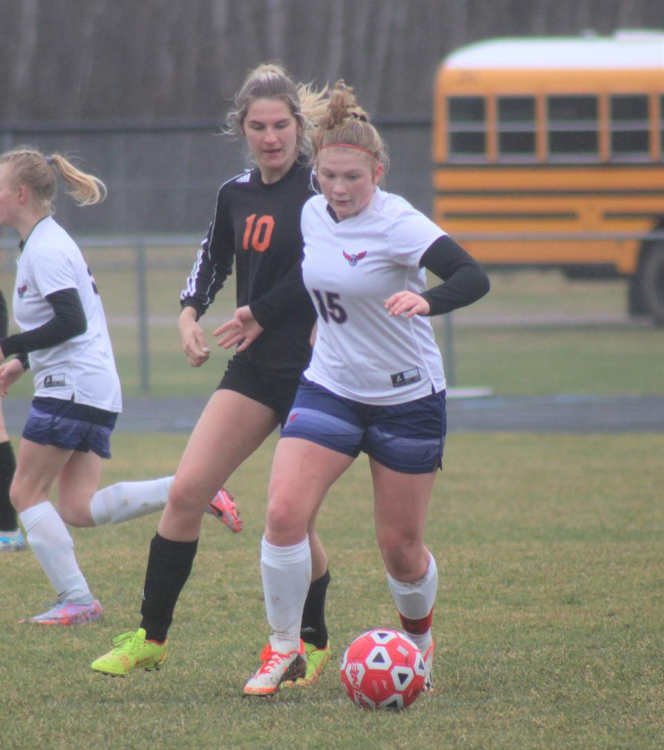 Boyne City sophomore Braydin Noble (15) looks to keep control of the ball while Cheboygan senior midfielder Lia Basanese (10) chases during the first half on Monday.