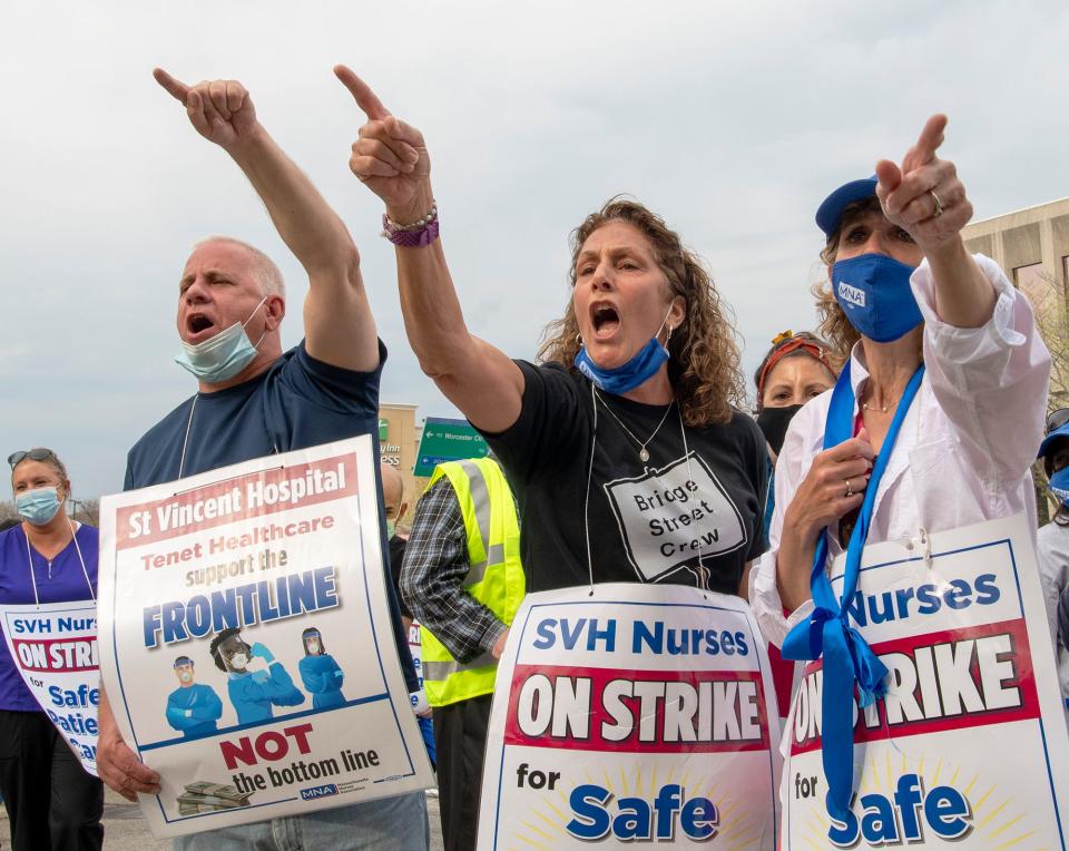 Supporter Paul Stuart, nurse Carolyn Moore and nurse Marlena Pellegrino yell at St. Vincent Hospital security personnel after Francis X. Callahan, president of the Massachusetts Building Trades Council, was denied entry into the hospital to deliver a letter to St. Vincent CEO Carolyn Jackson on April 28.