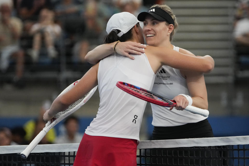 Poland's Iga Swiatek, left, is congratulated by Germany's Angelique Kerber following her win in the final of the United Cup in Sydney, Australia, Sunday, Jan. 7, 2024. (AP Photo/Mark Baker)