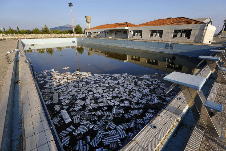 Garbage floats in a deserted swimming pool at the Olympic Village in Thrakomakedones, north of Athens, in July 2014.