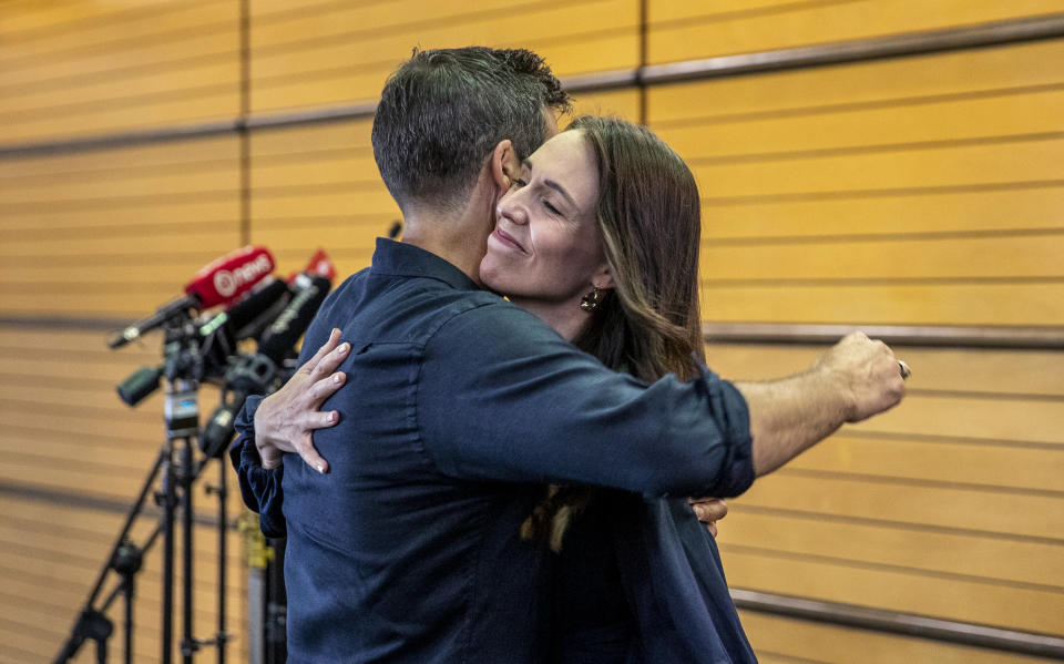 New Zealand Prime Minister Jacinda Ardern, right, hugs her fiancee Clark Gayford after announcing her resignation at a press conference in Napier, New Zealand, Thursday, Jan. 19, 2023. Fighting back tears, Ardern told reporters that Feb. 7 will be her last day in office. (Mark MItchell/New Zealand Herald via AP)