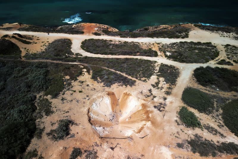 Aerial view shows a crater formed by an explosion on land that was fast-tracked for residential housing near the Mediterranean sea in Herzliya