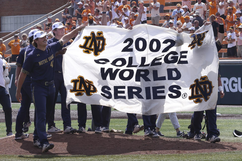 Notre Dame players celebrate after beating Tennessee in an NCAA college baseball super regional game Sunday, June 12, 2022, in Knoxville, Tenn. Notre Dame won 7-3 to advance to the College World Series. (AP Photo/Randy Sartin)