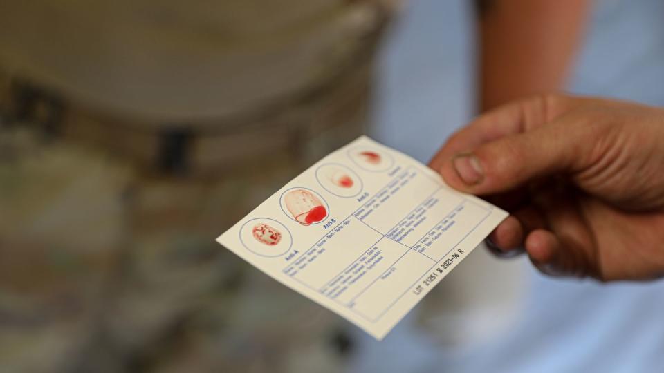 A U.S. Soldier assigned to 64th Brigade Support Battalion, 3rd Armored Brigade Combat Team, 4th Infantry Division, holds a blood type testing card during a walking blood bank training at Skwierzyna, Poland, Aug. 10, 2022. (Sgt. Tara Fajardo Arteaga/Army)