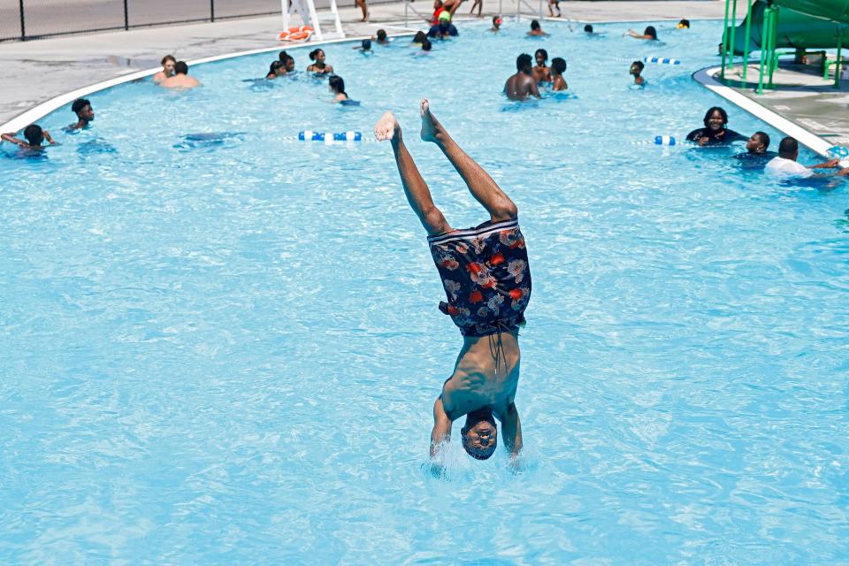 Kenyon Brown dives into the Lacy Park Pool, Friday, July 8, 2022 in Tulsa, Okla. It is the 5th day in a row for temperatures of 100 degrees Fahrenheit or more, the first time since July 2012.
