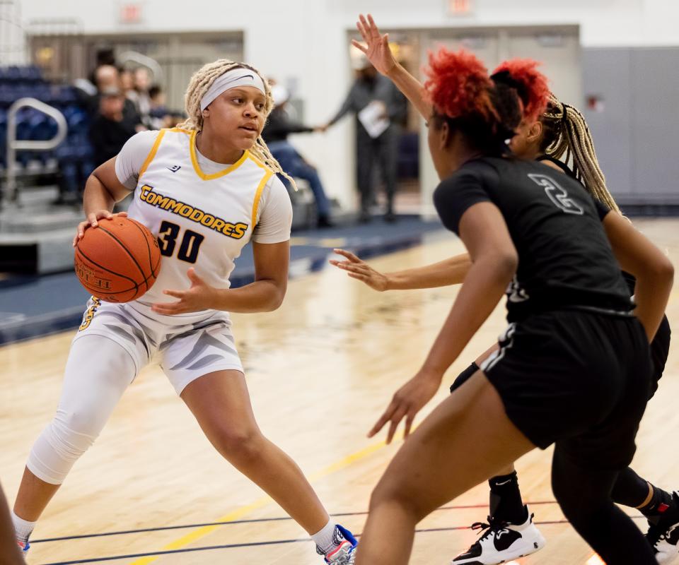 Morgan Robinson (30) is double teamed by a pair of Northwest Florida State defenders during a game on Tuesday, Jan. 4, 2022.