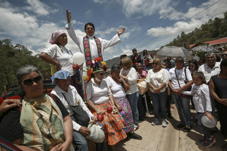 Neighbors receive the funeral procession of Jesuit priests Javier Campos Morales and Joaquin Cesar Mora Salazar in Cerocahui, Chihuahua state, Mexico, Sunday, June 26, 2022. The two elderly priests and a tour guide murdered in Mexico's Sierra Tarahumara this week are the latest in a long line of activists, reporters, travelers and local residents who have been threatened or killed by criminal gangs that dominate the region. (AP Photo/Christian Chavez)