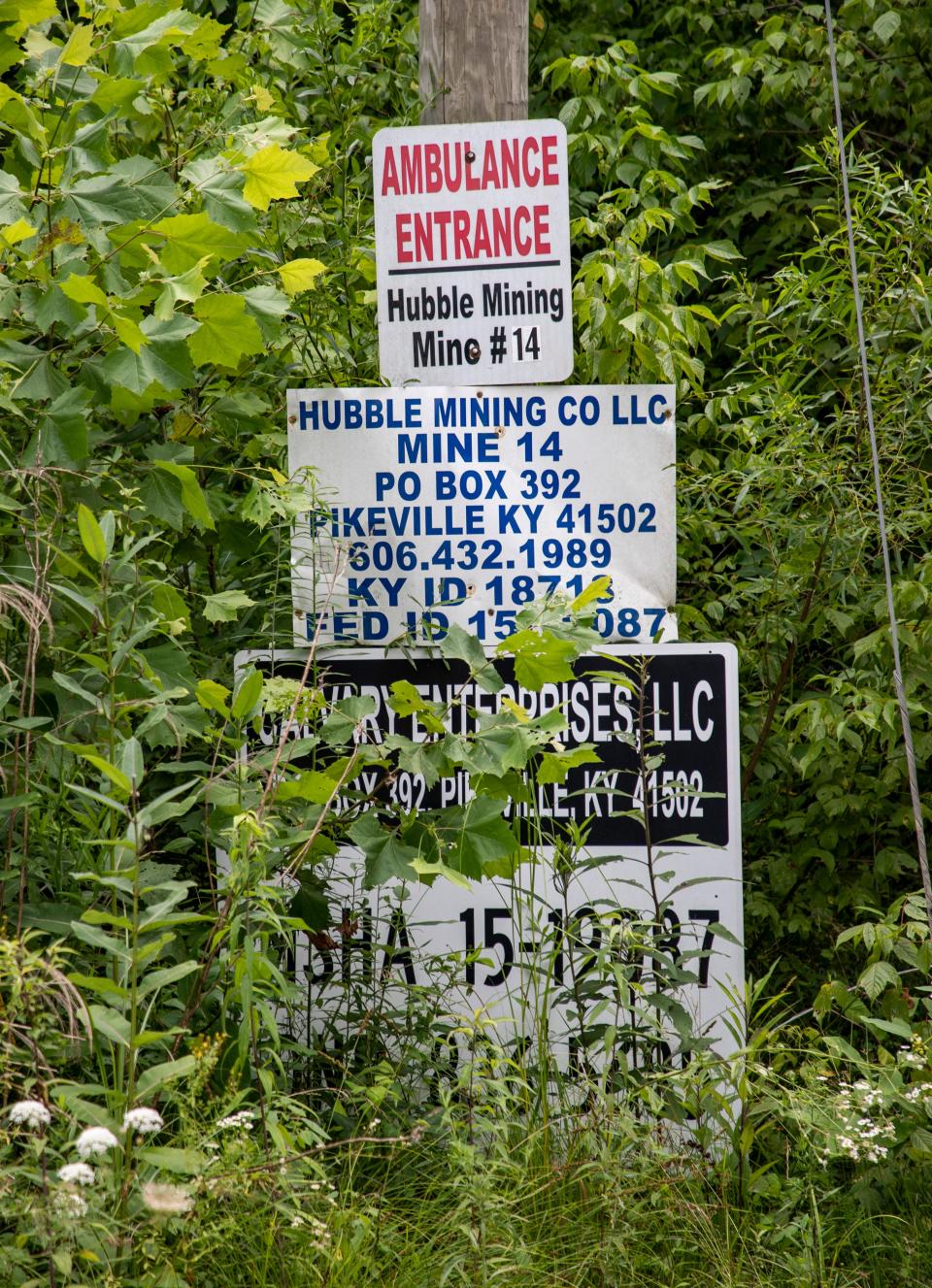 Former mining operation signs at the gated entrance to the strip mined property of the Neece family in Floyd County, Kentucky. July 15, 2021