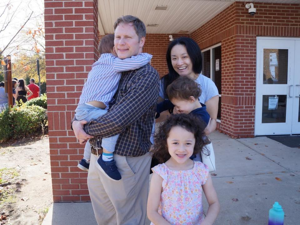 Jill and James Sherk wait in line with their three kids at an early voting site in Woodbridge, VA.