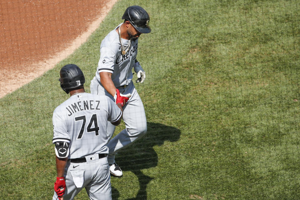 Chicago White Sox's Jose Abreu, right, is congratulated by Eloy Jimenez, left, after hitting a solo home run off of Chicago Cubs' Yu Darvish during the second inning of a baseball game, Sunday, Aug. 23, 2020, in Chicago. (AP Photo/Kamil Krzaczynski)